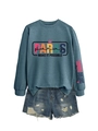 Close-up of the letter print on the grey sweatshirt and distressed denim shorts details - Blue (Black Graphic)