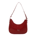 Glossy red patent leather underarm bag with silver bow accent and adjustable shoulder strap - Red