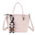 Pink faux leather bucket bag featuring a brown cartoon pendant and logo print - Pink With Pendant