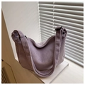 Close-up of lavender corduroy hobo bag texture with adjustable strap and buckle - Purple