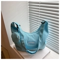 Détail du sac bandoulière croissant bleu clair avec porte-monnaie et logo FANYISSA - Style Sac dans le Sac / Bleu