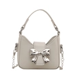 Mini beige leather handbag with large silver metal bow and silver chain strap - White
