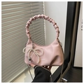Detail of light pink ruched handbag with pearl bow charm and metal chain strap - Pink