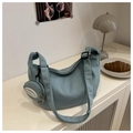 Close-up of light blue corduroy dumpling bag with a mini pouch in a lifestyle setting - Green