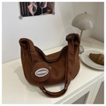 Detail of a brown corduroy crescent bag with a round mini pouch and logo patch - Brown