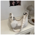 Detail of off-white waffle texture dumpling bag with adjustable strap and small coin purse - White