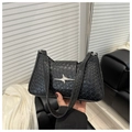 Chic black woven baguette underarm bag featuring a metallic star charm detail - Black