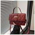 Detail of burgundy quilted crossbody bag with golden H buckle and elegant stitching - Red