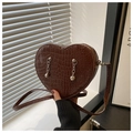 Detail of dark brown heart-shaped bag with faux crocodile skin texture and silver chains - Brown