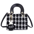 Chic black and white tweed handbag with top handle, gold hardware and furry charm - Black With Pendant
