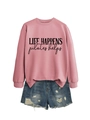 Detailed flat lay of pink Life Happens Pilates Helps sweatshirt and ripped denim shorts - Rose Gold (Black Print)