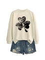 Flat lay of beige crewneck sweatshirt with distressed clover print and denim shorts - S / Sand (Black Shamrock Print)