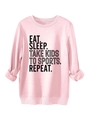 Close-up of pink crewneck sweatshirt featuring black EAT SLEEP TAKE KIDS TO SPORTS text - Pink