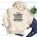 Detail of apricot hoodie featuring black text print, drawstring hood, and front pocket - S / Sand
