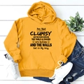 Flat lay of yellow hoodie featuring I'm Not Clumsy text with drawstring and kangaroo pocket - S / Yellow