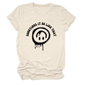 Detail of graffiti-style smiley face and text print on cream crew neck cotton t-shirt - S / Sand (Black Text)