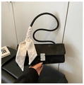 Detail of black suede baguette bag with wavy handle, silk scarf and diamond-set silver buckle - Black