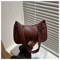 Close-up of wine red woven leather shoulder bag with gold zipper and textured surface - Dark Brown