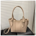 Detail view of pinkish PU leather handbag showing trapezoidal shape and metal hardware - Khaki