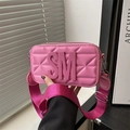 Pink quilted crossbody bag featuring large 3D letters and a wide woven shoulder strap - Pink