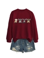 Detail of burgundy sweatshirt featuring colorful highland cow prints and ripped denim shorts - S / Burgundy