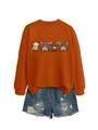 Detail of orange crewneck sweatshirt featuring four cartoon highland cows and distressed denim - S / Burnt Orange
