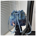 Detail of blue denim bucket bag with green star patterns and trendy frayed edges - Star - Rainbow