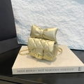 Golden quilted mini crossbody bag with a large decorative bow and metallic chain strap - Gold