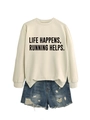 Detail view of Life Happens Running Helps slogan print on a cream crewneck sweatshirt - Sand (Black Font)