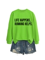 Flat lay of green sweatshirt featuring Life Happens Running Helps text with denim shorts - Fluorescent Green (Black Font)