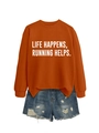 Flat lay of an orange sweatshirt with 'LIFE HAPPENS, RUNNING HELPS' text and denim shorts - Burnt Orange (White Font)