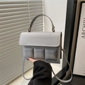 Detail of grey-blue square handbag with 3D geometric embossed squares and thick handle - Gray