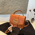 Vintage orange-brown faux leather handbag with large gold buckle and crossbody strap - Brown