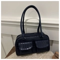 Detail view of dark blue crocodile texture handbag with two front pockets and long handles - Blue