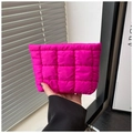 Detailed close-up of a rose pink quilted puffy cosmetic bag held in hand - Rose Red