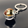 Silver keychain with glass dome featuring four cute sitting cats illustration - Four Cats Sitting in Row(XSWX2233-5)