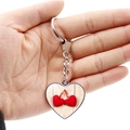 Silver heart-shaped keychain pendant with red heart pattern held by hand for scale - Cherry Red Double Heart (JY008683-5)