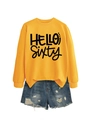 Flat lay of a yellow sweatshirt with HELLO SIXTY print and distressed denim shorts - Yellow Sweatshirt (Black Font)