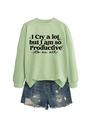 Flat lay of a mint green sweatshirt with quote print and distressed denim shorts set - S / Olive Green Sweatshirt (Black Text)