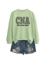 Flat lay of light green CNA Certified Nursing Assistant sweatshirt and distressed denim shorts - Olive Green (Black Font)