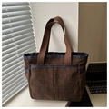 Detailed view of corduroy tote bag with multiple pockets and striped trim in soft light - Coffee