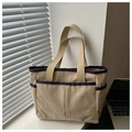 Detailed corduroy tote bag showing side pocket texture and contrast blue trim finish - Khaki