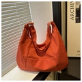 Detalle de bolso hobo naranja con correa ajustable y textura de tela impermeable - Naranja