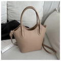 Detail of beige faux leather bucket bag with wavy rim, gold hardware, and long strap - Khaki