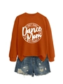 Flat lay of burnt orange crewneck sweatshirt with white graphic print and distressed denim shorts - Burnt Orange (White Font)