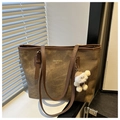 Detailed close-up of brown large capacity tote bag with white plush charm on window sill - Coffee with Pendant