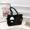 Black corduroy tote bag with cloud pendant and wide base shown in a minimalist setting - Black With Pendant