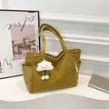 Large mustard yellow corduroy tote bag with side pocket and cloud charm on a podium - Yellow With Pendant