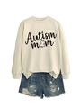 Close-up of Autism Mom sweatshirt with puzzle piece graphic and ripped denim shorts - Sand (Black Font)