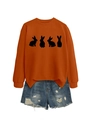 Detail of orange crewneck sweatshirt with four black rabbit silhouettes and denim shorts - Burnt Orange (Black Rabbit)